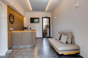 a living room with a couch and a tv at Ionian Arches in Gouvia