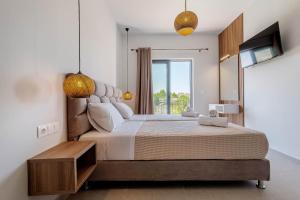 a bedroom with a large bed and a window at Ionian Arches in Gouvia