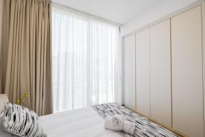 a bedroom with a bed and a large window at MITO Seaview by Serbellas in Kissonerga