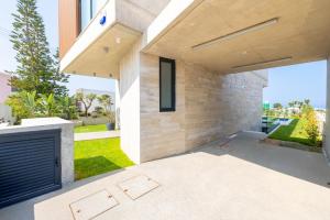 a view of a house with a patio at MITO Seaview by Serbellas in Kissonerga