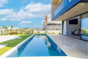 a swimming pool in the backyard of a house at MITO Seaview by Serbellas in Kissonerga