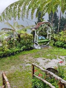 a garden with a white fence and some flowers at Green Haven in Kalimpong +2 photos