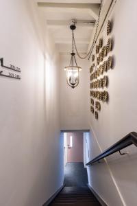 a hallway with a wine rack and a chandelier at Heritage Collection on Victoria - Mobile App Check-In in Singapore