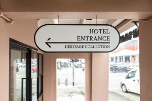 a hotel entrance sign hanging from a building at Heritage Collection on Victoria - Mobile App Check-In in Singapore +40 photos