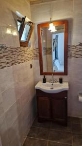 a bathroom with a sink and a mirror at Ada in Kamáres