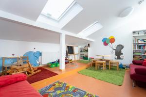 a living room with a couch and a childs room at Jugendherberge Bad Urach in Bad Urach