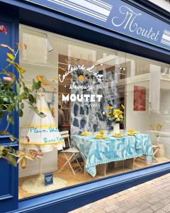 a store window with a table in front of it at Havre de paix in La Celle-sous-Gouzon