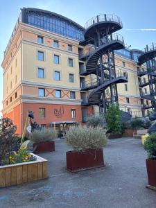 a building with a spiral staircase in front of it at Dali Hôtel Montauban in Montauban