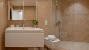 a bathroom with a sink and a shower and a toilet at Villa Soul Sisters in Korčula
