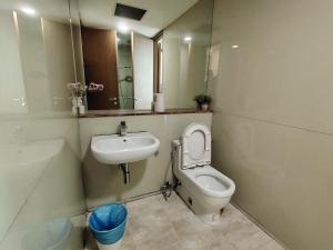 a bathroom with a sink and a toilet and a mirror at Soho Suites Kualalampur by homestay klcc in Kuala Lumpur +11 photos