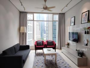 a living room with a couch and two chairs at Soho Suites Kualalampur by homestay klcc in Kuala Lumpur