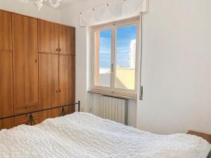 a bedroom with a bed and a window at Vista Mare nel Corso in San Vincenzo