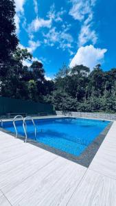 a swimming pool with a blue sky in the background at Rivera Holidays in Vythiri