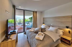 a bedroom with a large bed and a balcony at Villa Soul Sisters in Korčula