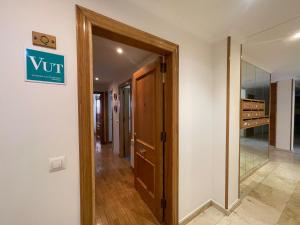 a hallway with a door and a sign on a wall at Amplio Loft con plaza de garaje in Cangas de Onís