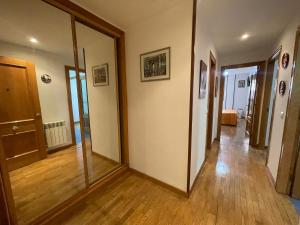 a hallway with a large mirror in a house at Amplio Loft con plaza de garaje in Cangas de Onís
