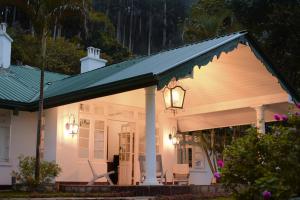 a white house with a green roof at Andriyala in Haputale