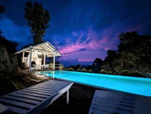 a swimming pool at night with a gazebo at Andriyala in Haputale +62 photos