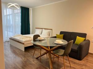 a bedroom with a bed and a table and a couch at Chantrer in Burgas