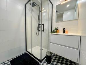 a glass shower in a bathroom with a sink at Cocoon Studio Ciel de Fabron in Nice +12 photos