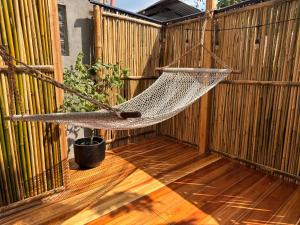 a hammock hanging from a fence on a patio at Pads Guesthouse in San Vicente