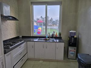 a kitchen with a sink and a window at Katara Garden in As Suwayq