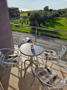 a table and chairs on a balcony with a view at Lavanda Samarin in Zambratija