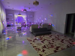 a living room with a couch and a rug at Katara Garden in As Suwayq