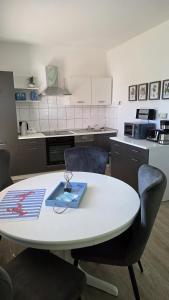 a table with a book on it in a kitchen at Schwedenhaus, Am Achterwasser, Urlaub mit Hund in Lütow