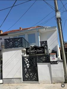a white house with a sign in front of it at Central Lux Stay Prilep in Prilep
