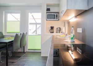 a kitchen with a counter and a table with chairs at Haus Jungmann in Hallenberg