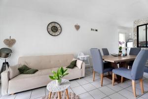 a living room with a couch and a table at Le Cocon De Laurence in Pleurtuit