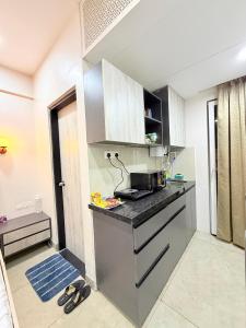 a kitchen with a stove and a counter top at The Sakshi suite - Luxury Saty with Premium Comfort in Jaipur +15 photos