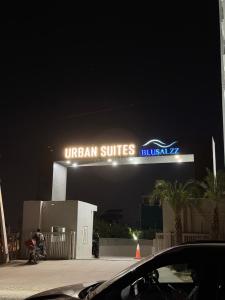 a lit up sign on a building at night at The Sakshi suite - Luxury Saty with Premium Comfort in Jaipur