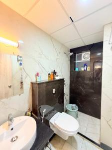 a bathroom with a white toilet and a sink at The Sakshi suite - Luxury Saty with Premium Comfort in Jaipur