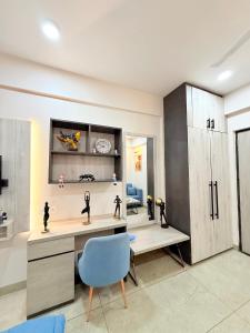 a home office with a desk and a blue chair at The Sakshi suite - Luxury Saty with Premium Comfort in Jaipur