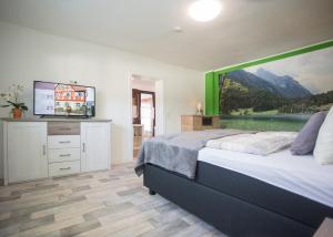 a bedroom with a bed with a large painting on the wall at Haus Jungmann in Hallenberg
