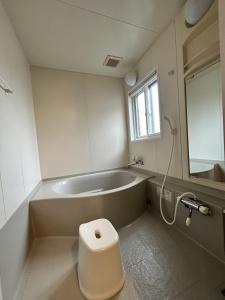 a bathroom with a tub and a toilet and a sink at AOMORI LOVERS Minatomachi Base in Aomori +72 photos
