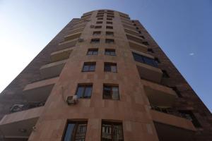 a tall brick building with a blue sky in the background at City View 2BR With Balcony, Steps To Cascade And North Avenue l New Building in Yerevan