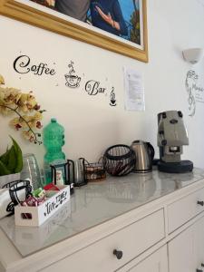a kitchen counter top with a coffee maker and a shelf at Capri Melody in Anacapri