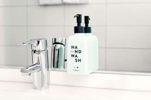 a bottle of shampoo next to a bathroom sink at Scandic Wrocław in Wrocław