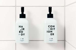 a group of three shampoo bottles on a shelf at Scandic Wrocław in Wrocław +63 photos