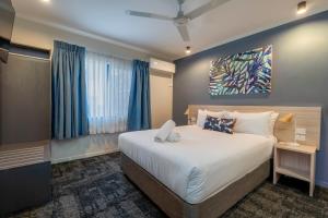 a bedroom with a large bed and a window at Cairns Southgate Hotel in Cairns +21 photos