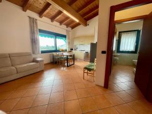 a living room with a couch and a table at Al Colle in Cavaion Veronese