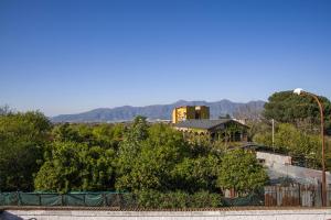 a building on a hill with trees and a street light at Way to Coast in Sant'Egidio del Monte Albino