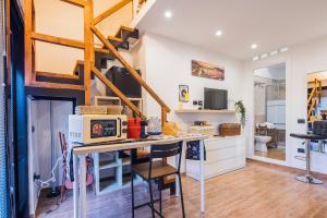 a kitchen and dining room with a table with a microwave at Way to Coast in Sant'Egidio del Monte Albino