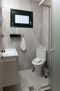a bathroom with a toilet and a sink at Zeusplace Crown Platamon in Platamonas +68 photos