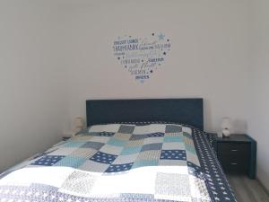 a bedroom with a bed with a heart on the wall at Haus Bischoff 1 in Halblech