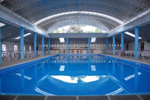 a large swimming pool with a large ceiling at Balay Tuko Garden Inn in Puerto Princesa City