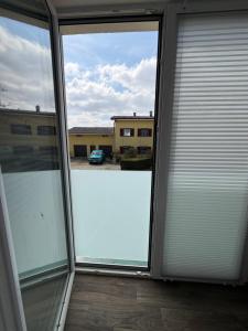 an empty room with sliding glass doors in a building at Comfort Collection Podersdorf am See in Podersdorf am See